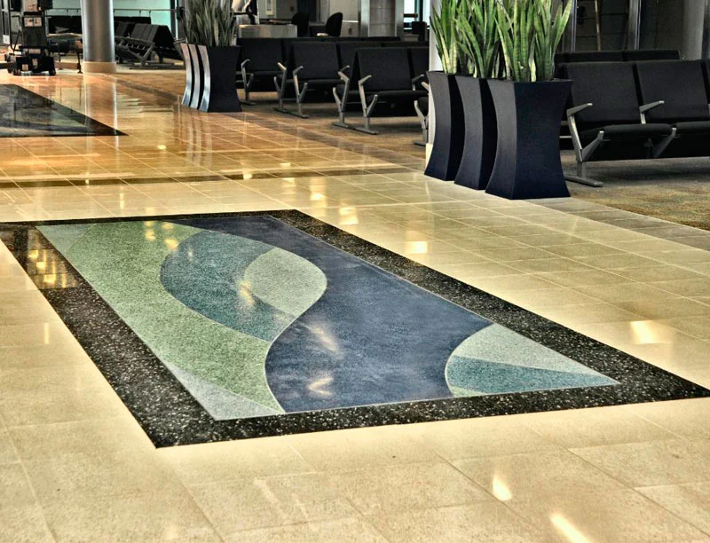 Polished lobby floor with a decorative blue and green inlay