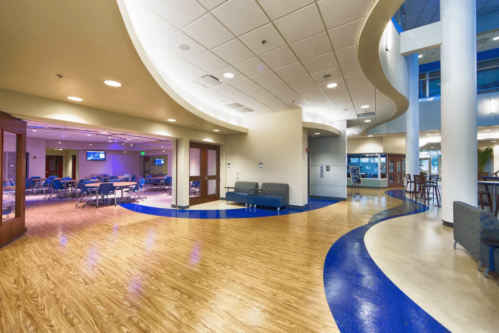 Commercial lobby with wood-look flooring and a curved blue inlay