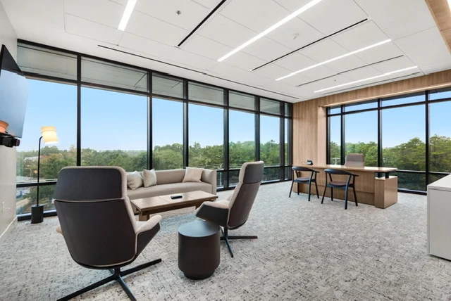 Office lounge with carpet flooring and floor-to-ceiling windows