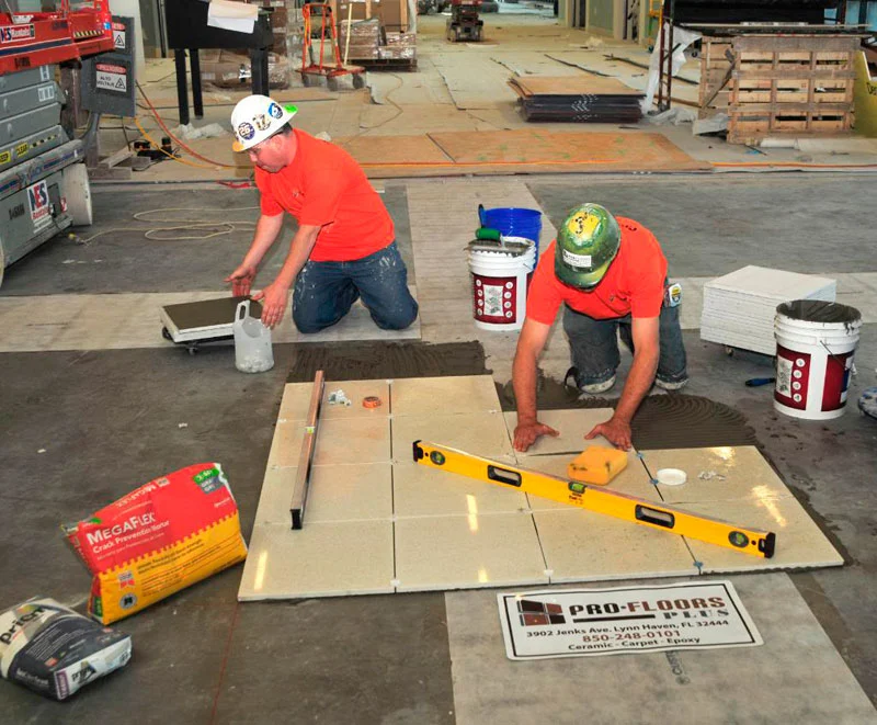 Pro-Floors Plus commercial flooring contractor crew setting large-format tile